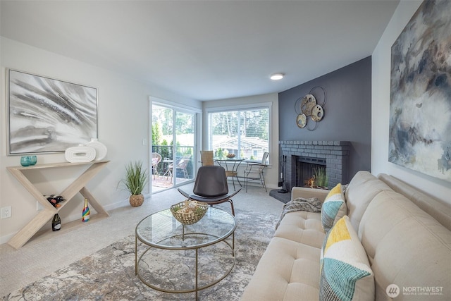 11215 NE 128th St Unit L-203, Kirkland, WA 98034 - carpeted living area featuring a brick fireplace and baseboards