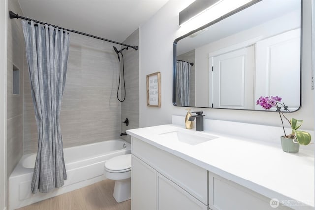 11215 NE 128th St Unit L-203, Kirkland, WA 98034 - bathroom featuring vanity, shower / tub combo with curtain, toilet, and wood finished floors