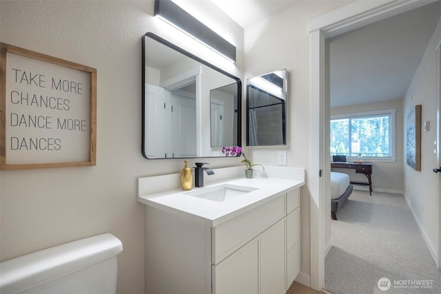 11215 NE 128th St Unit L-203, Kirkland, WA 98034 - full bathroom with toilet, vanity, and baseboards
