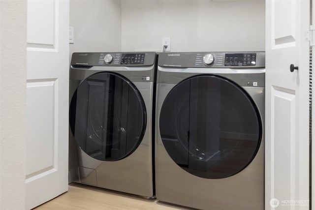 11215 NE 128th St Unit L-203, Kirkland, WA 98034 - laundry room with washer and dryer and light wood finished floors