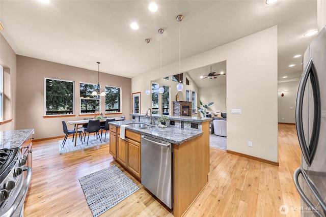8 Southern Ct, Bellingham, WA 98229 - kitchen featuring appliances with stainless steel finishes, stone counters, light wood finished floors, recessed lighting, and lofted ceiling