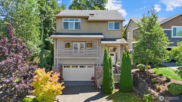 2025 NE 37th Pl, Renton, WA 98056 - view of front of house featuring an attached garage, asphalt driveway, stone siding, and roof with shingles