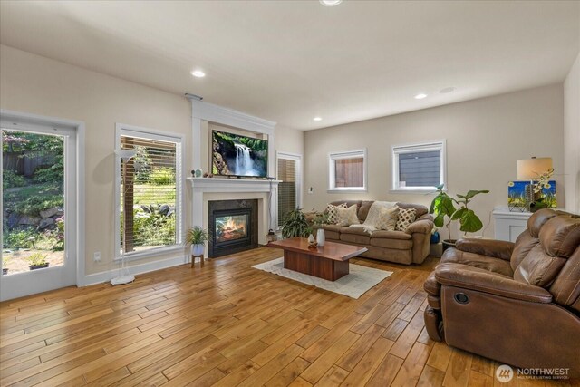 2025 NE 37th Pl, Renton, WA 98056 - living room with light wood-type flooring, a glass covered fireplace, and recessed lighting