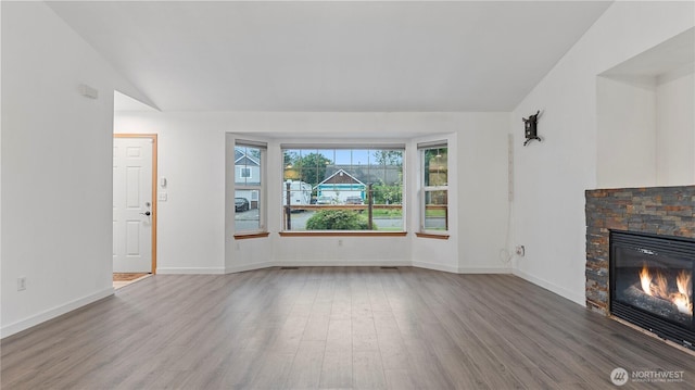 215 19th St, Gold Bar, WA 98251 - unfurnished living room with lofted ceiling, wood finished floors, a fireplace, and baseboards