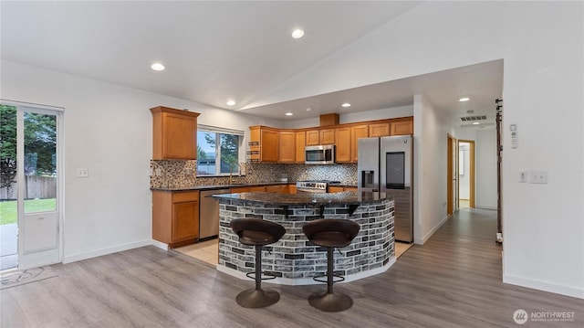 215 19th St, Gold Bar, WA 98251 - kitchen with appliances with stainless steel finishes, tasteful backsplash, healthy amount of natural light, a kitchen island, and vaulted ceiling