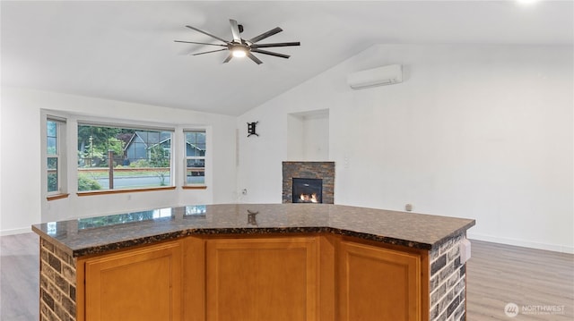 215 19th St, Gold Bar, WA 98251 - kitchen with an AC wall unit, lofted ceiling, light wood finished floors, a ceiling fan, and baseboards