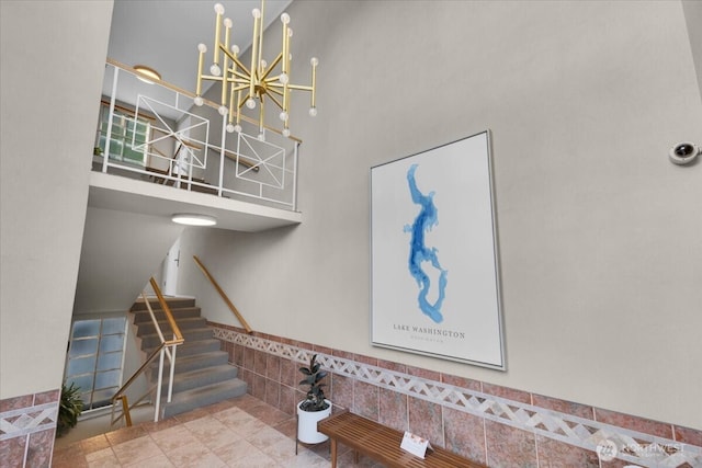 720 Lakeside Ave S Unit 406, Seattle, WA 98144 - stairway featuring a high ceiling and a chandelier
