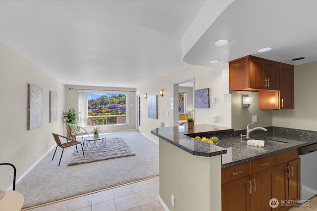 720 Lakeside Ave S Unit 406, Seattle, WA 98144 - kitchen with stainless steel dishwasher, light carpet, a sink, open floor plan, and dark stone countertops