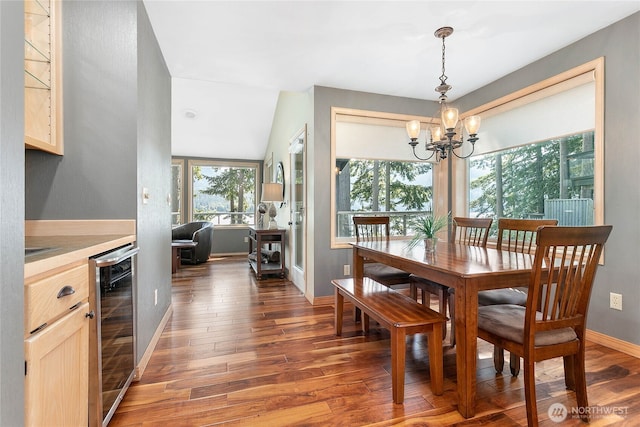 8 Far Summit Pl, Bellingham, WA 98229 - dining space with beverage cooler, a chandelier, wood finished floors, and baseboards