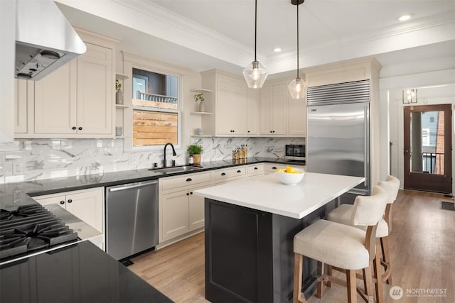 3807 E Jefferson St, Seattle, WA 98122 - kitchen with open shelves, a sink, island exhaust hood, stainless steel appliances, and a kitchen bar