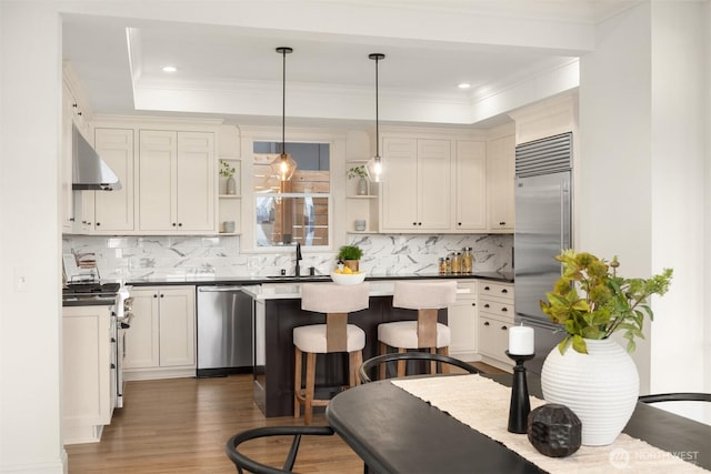 3807 E Jefferson St, Seattle, WA 98122 - kitchen with stainless steel appliances, open shelves, dark wood finished floors, under cabinet range hood, and tasteful backsplash