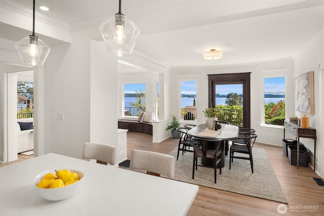 3807 E Jefferson St, Seattle, WA 98122 - dining space featuring ornamental molding, light wood finished floors, a water view, recessed lighting, and baseboards