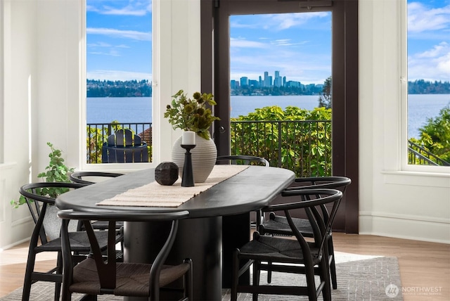 3807 E Jefferson St, Seattle, WA 98122 - dining space featuring baseboards, wood finished floors, and a water view
