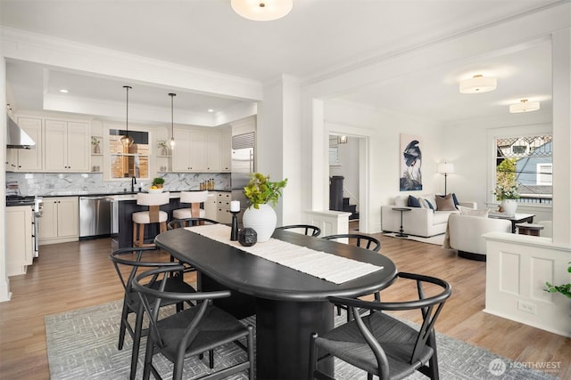 3807 E Jefferson St, Seattle, WA 98122 - dining space featuring wood finished floors, ornamental molding, a tray ceiling, stairway, and recessed lighting