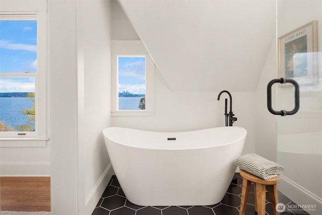 3807 E Jefferson St, Seattle, WA 98122 - bathroom featuring a freestanding bath, baseboards, and lofted ceiling