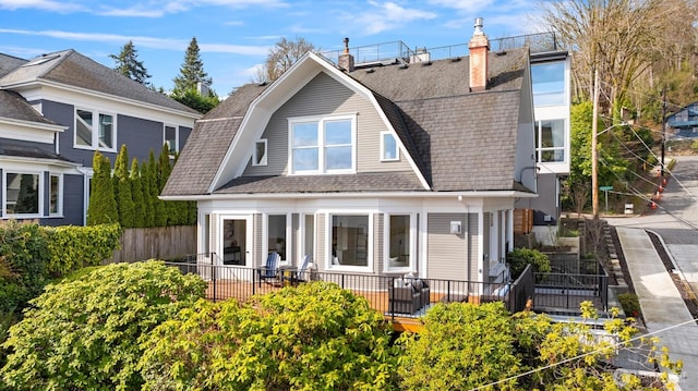 3807 E Jefferson St, Seattle, WA 98122 - rear view of property featuring a gambrel roof, a chimney, and a shingled roof
