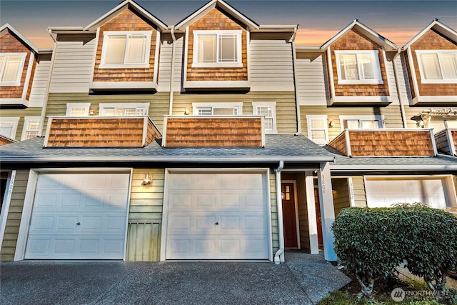 3604 22nd Ave W, Seattle, WA 98199 - view of property featuring a balcony, an attached garage, and driveway