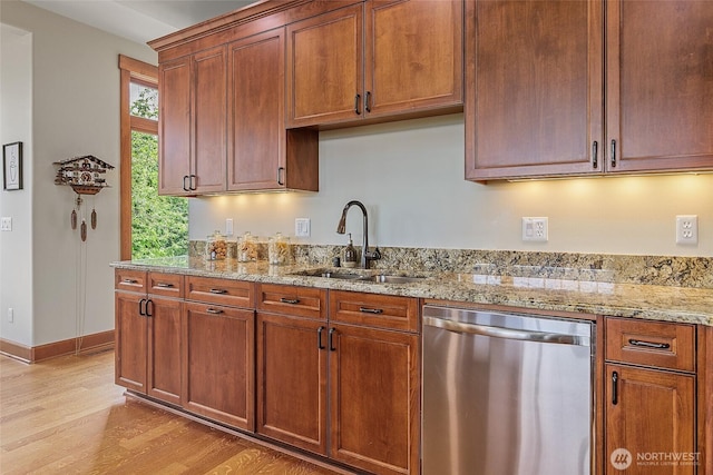 3430 Sevenich Dr, Everett, WA 98201 - kitchen featuring stainless steel dishwasher, a sink, light wood-style flooring, and light stone counters