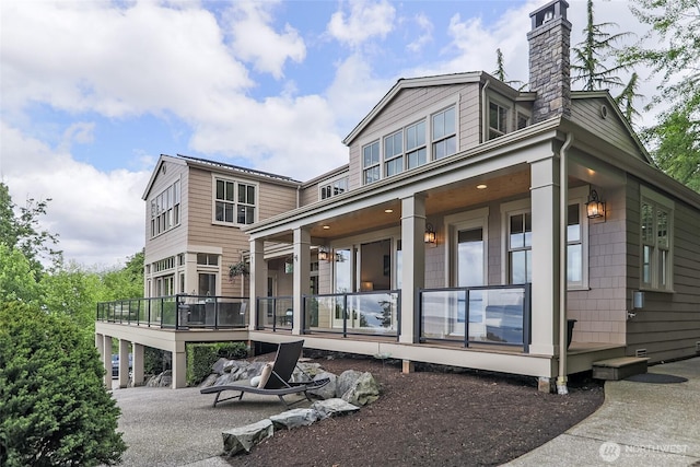 3430 Sevenich Dr, Everett, WA 98201 - rear view of property with a chimney and covered porch