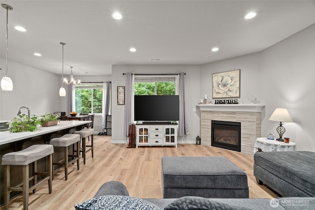 1116 NE 14th Way, Battle Ground, WA 98604 - living area with recessed lighting, light wood-type flooring, a chandelier, a tile fireplace, and baseboards