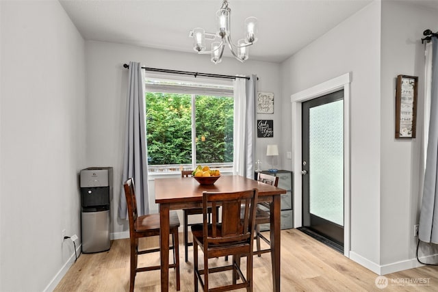 1116 NE 14th Way, Battle Ground, WA 98604 - dining room featuring light wood-style flooring, a chandelier, and baseboards