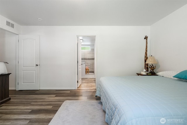 477 SE Old Arcadia Rd, Shelton, WA 98584 - bedroom with wood finished floors, baseboards, and connected bathroom