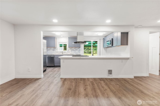 24028 135th Ave SE, Kent, WA 98042 - kitchen featuring island range hood, appliances with stainless steel finishes, light wood finished floors, baseboards, and recessed lighting