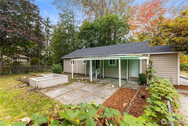 24028 135th Ave SE, Kent, WA 98042 - rear view of property with roof with shingles and a vegetable garden