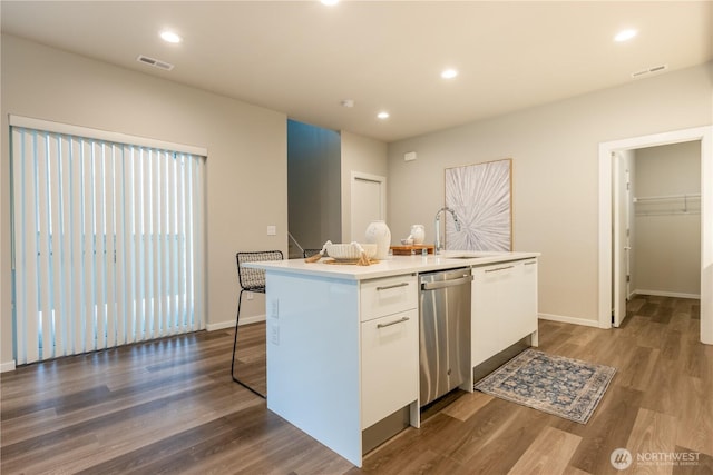 33488 Golden Lakes Ln SE, Black Diamond, WA 98010 - kitchen featuring a sink, stainless steel dishwasher, white cabinets, an island with sink, and dark wood-style flooring