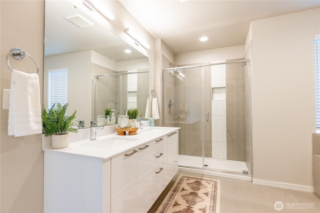 33488 Golden Lakes Ln SE, Black Diamond, WA 98010 - bathroom featuring tile patterned floors, double vanity, a shower stall, recessed lighting, and baseboards