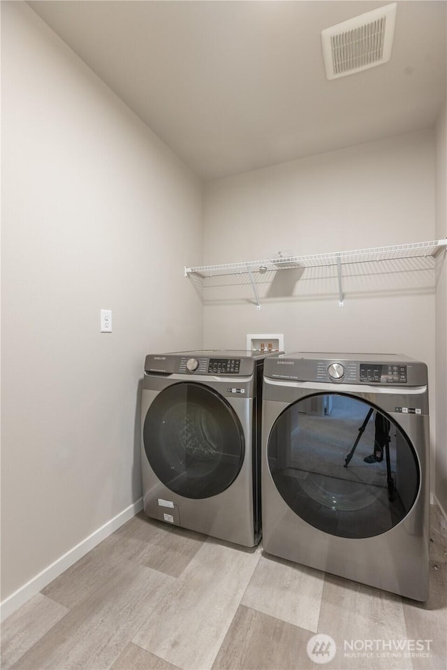 33488 Golden Lakes Ln SE, Black Diamond, WA 98010 - washroom with washer and dryer, wood finished floors, and baseboards