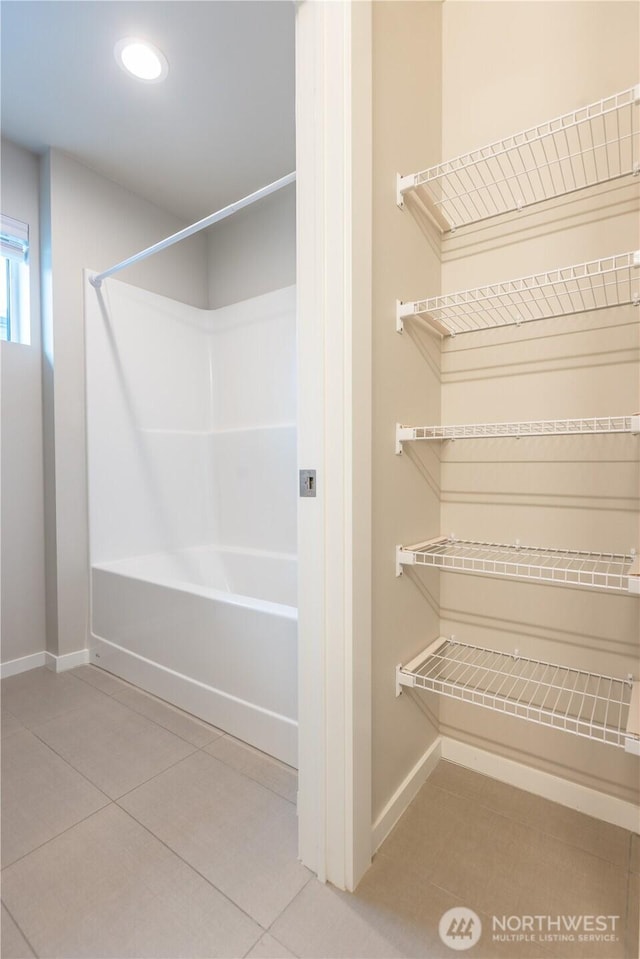 33488 Golden Lakes Ln SE, Black Diamond, WA 98010 - bathroom featuring baseboards, washtub / shower combination, and tile patterned flooring