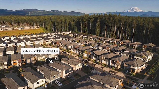 33488 Golden Lakes Ln SE, Black Diamond, WA 98010 - aerial view of property's location featuring mountains, nearby suburban area, and a heavily wooded area