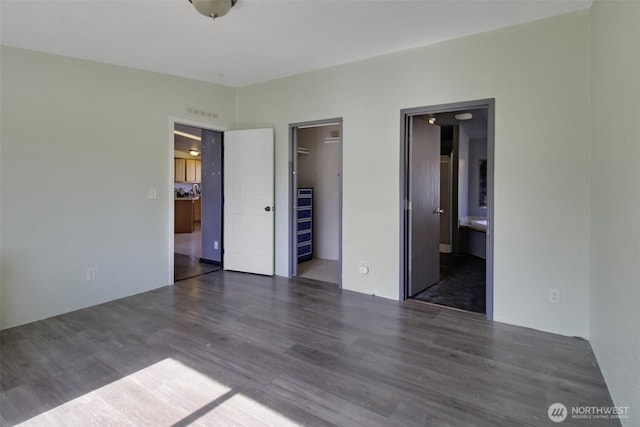 524 New Gate Dr, Prosser, WA 99350 - unfurnished bedroom with wood finished floors, a spacious closet, ensuite bath, and a closet
