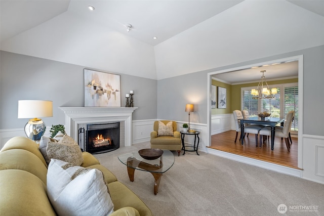 20520 NE 35th Pl, Sammamish, WA 98074 - living area featuring carpet floors, a chandelier, vaulted ceiling, a lit fireplace, and a wainscoted wall