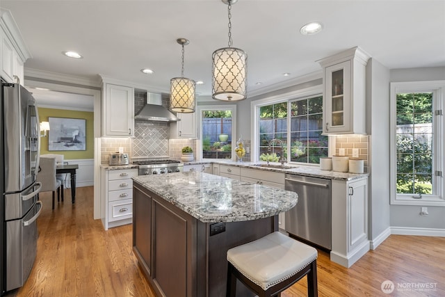 20520 NE 35th Pl, Sammamish, WA 98074 - kitchen featuring appliances with stainless steel finishes, wall chimney range hood, white cabinets, backsplash, and plenty of natural light