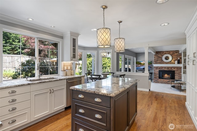 20520 NE 35th Pl, Sammamish, WA 98074 - kitchen featuring stainless steel dishwasher, white cabinets, plenty of natural light, light stone countertops, and recessed lighting