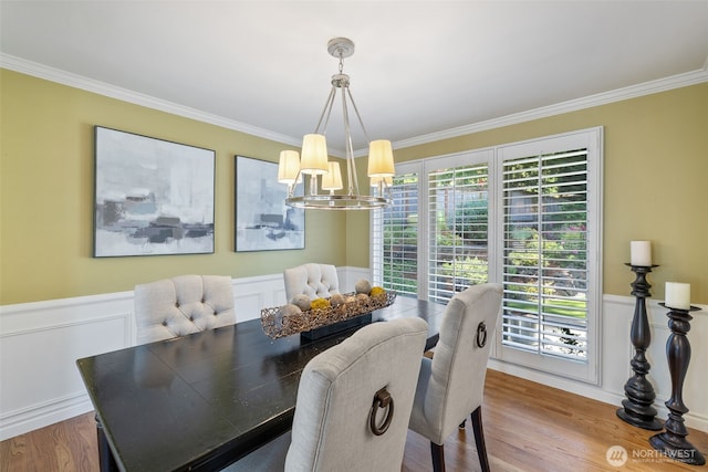 20520 NE 35th Pl, Sammamish, WA 98074 - dining area featuring a chandelier, crown molding, wood finished floors, and wainscoting