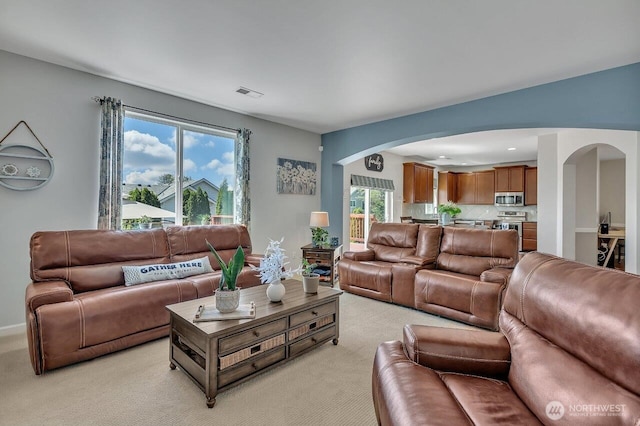 6715 Quincy Ave SE, Auburn, WA 98092 - living area featuring arched walkways and light colored carpet