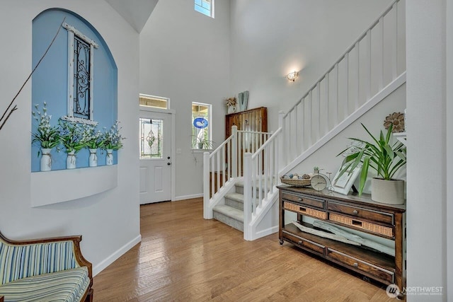 6715 Quincy Ave SE, Auburn, WA 98092 - foyer with stairs, plenty of natural light, baseboards, wood finished floors, and a high ceiling