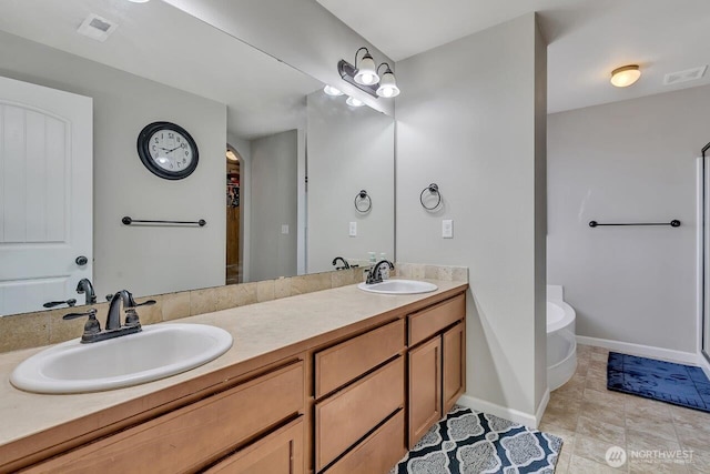 6715 Quincy Ave SE, Auburn, WA 98092 - bathroom featuring double vanity, a freestanding bath, baseboards, and tile patterned flooring