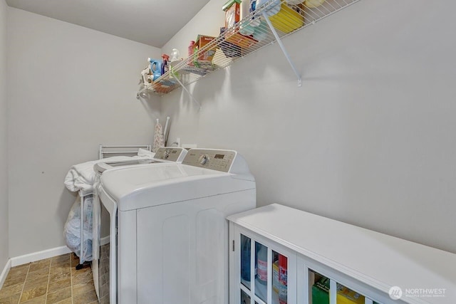6715 Quincy Ave SE, Auburn, WA 98092 - washroom with separate washer and dryer, baseboards, and stone finish floors
