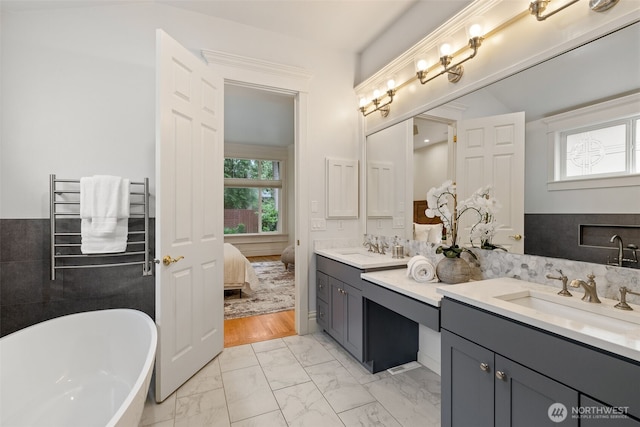 2728 206th Ter NE, Sammamish, WA 98074 - ensuite bathroom with double vanity, marble look tiles, and a soaking tub