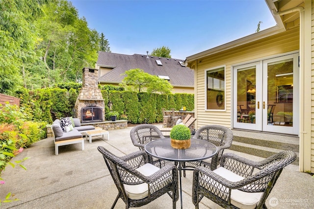 2728 206th Ter NE, Sammamish, WA 98074 - view of patio / terrace with an outdoor stone fireplace and french doors