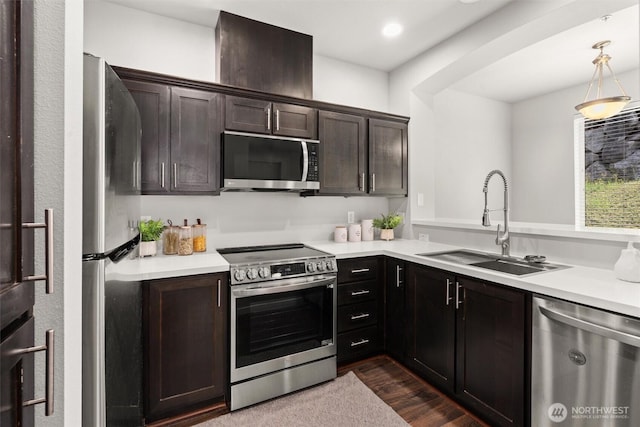 1900 Weaver Rd Unit C106, Snohomish, WA 98290 - kitchen featuring stainless steel appliances, light countertops, dark brown cabinetry, dark wood-style floors, and hanging light fixtures