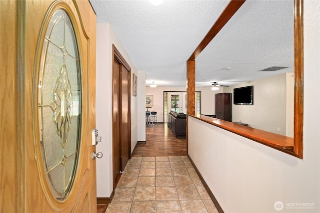 3318 18th Ave SE, Olympia, WA 98501 - hall featuring a textured ceiling, baseboards, and light tile patterned flooring