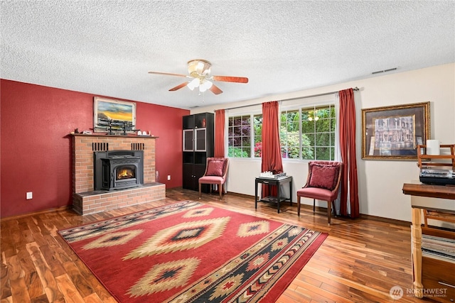 3318 18th Ave SE, Olympia, WA 98501 - living room with a textured ceiling, a ceiling fan, hardwood / wood-style flooring, and baseboards
