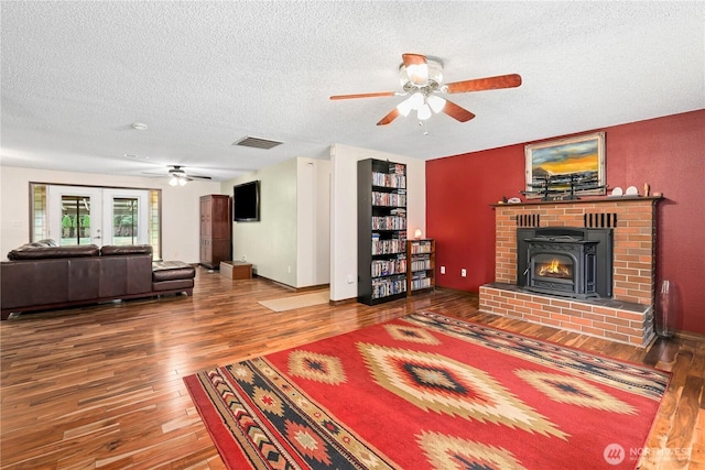 3318 18th Ave SE, Olympia, WA 98501 - living area featuring ceiling fan, hardwood / wood-style floors, a textured ceiling, a fireplace, and built in features