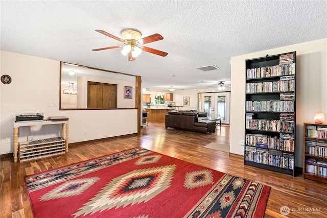 3318 18th Ave SE, Olympia, WA 98501 - living area with a ceiling fan, a textured ceiling, wood finished floors, and baseboards