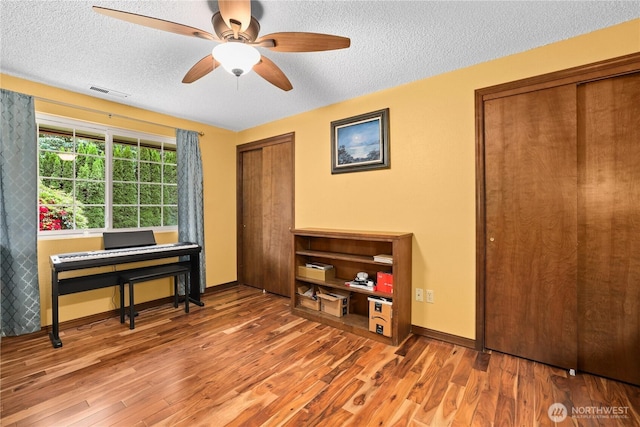 3318 18th Ave SE, Olympia, WA 98501 - office with a textured ceiling, wood finished floors, ceiling fan, and baseboards
